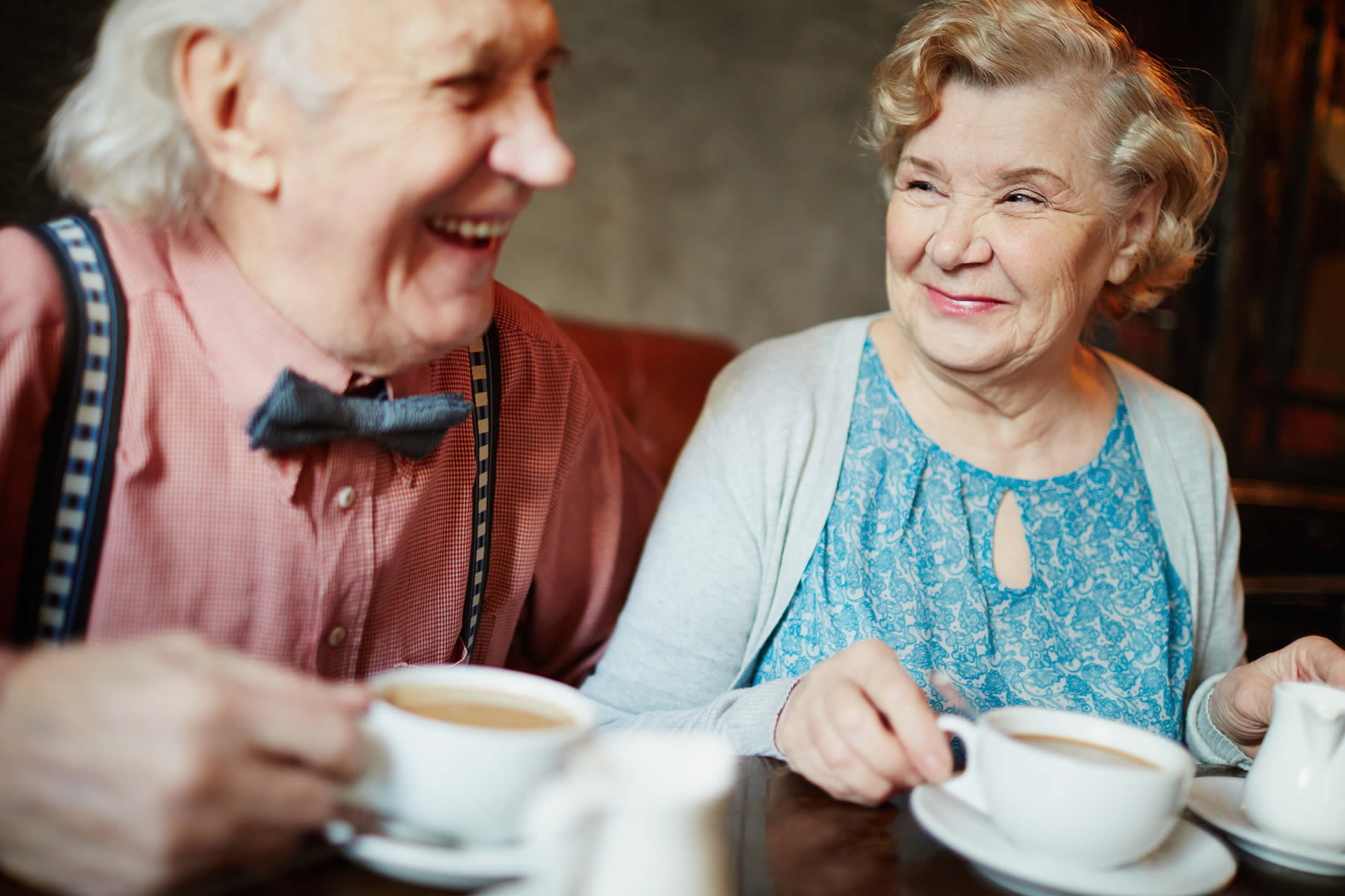 Senior couple smiling and drinking coffee together